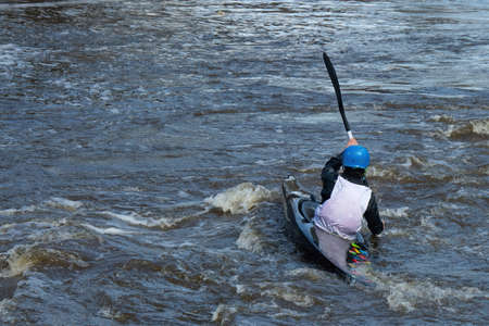 A series of images. Athletes in kayaks and kayaks conquer the stormy waters of the river. Dressed in...