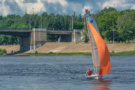 Tver Russia July 17, 2022: Yacht competitions on the river in summer on a sunny day. There are green trees in the background. beautiful cloudy skyのeditorial素材