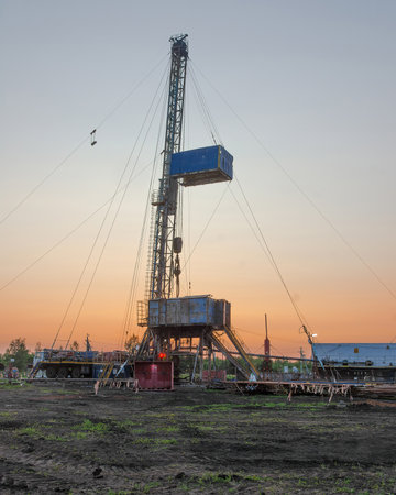 Drilling a well in an oil field. Mobile drilling rig and drilling equipment. Summer. Beautiful sky...
