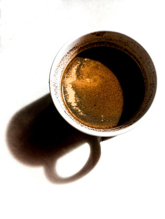 Coffee milk in a mug and its shadowの写真素材