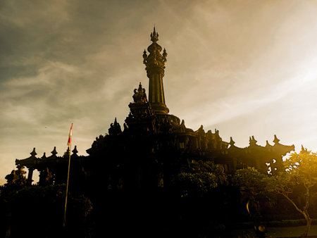 Dramatic silhouette of Bajra Sandhi Monument at sunset, Bali.の写真素材