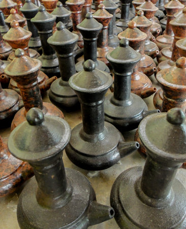 A terracotta and dark glaze clay teapot with a distinctive traditional design, perfect for home decor, tea enthusiasts and collectors of unique artisanal ceramics.の写真素材