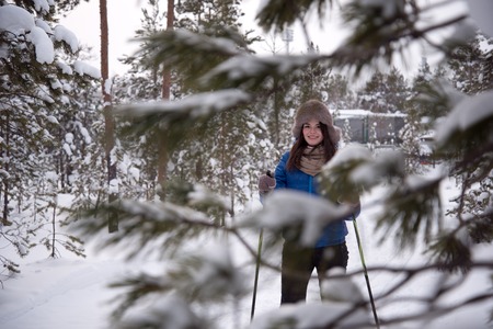 Beautiful girl skiing in the woodsの写真素材