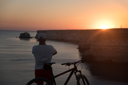 The man with the bike on the coastの写真素材