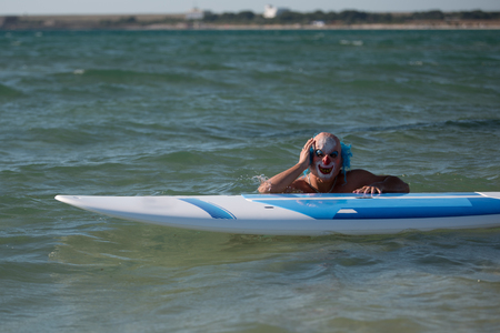 Man in mask posing with boardの写真素材