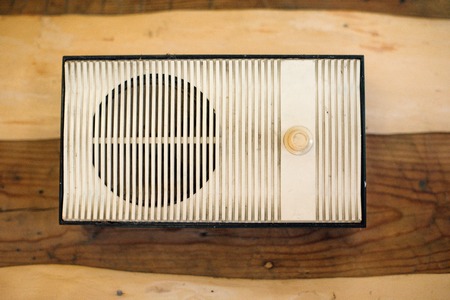 The radio hanging on wood background on the wallの写真素材