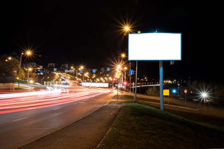 The form of the night's Billboard on the background of the city, roads and road signsの写真素材