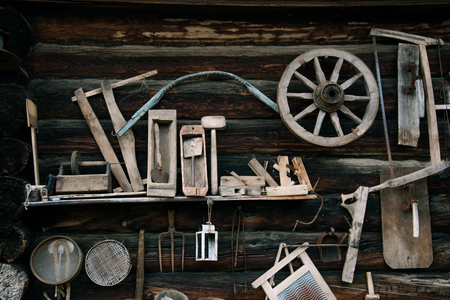 Vintage wooden tools hanging on the wooden wallの写真素材