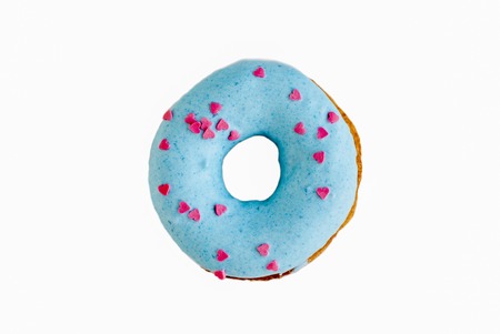 Blue donut sprinkled with small pink hearts on white isolate backgroundの写真素材
