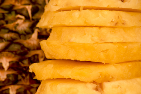 Cut circles from the slices of pineapple and the pineappleの写真素材