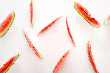 Slices of red delicious juicy watermelon on a white table . Top viewの写真素材