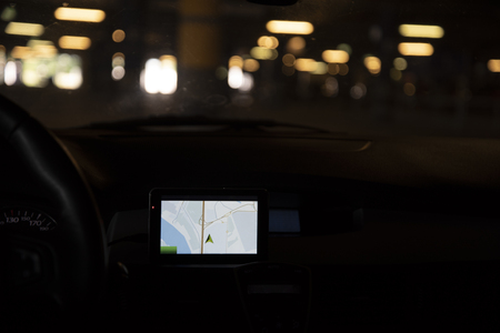 The car with the Navigator is in the Parking lot. View from inside the car.