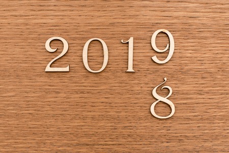 The inscription 2019 and past years, symbolizing the onset of the new year. Wooden surface. The view...
