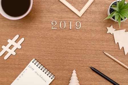 Lettering 2019 and all sorts of stationery items on the wooden surface. Flat lay for designersの写真素材