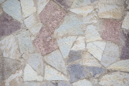 Stone wall of flat large beautiful stones of different colorsの写真素材