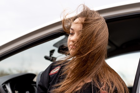 Young beautiful woman whose hair flutters in the windの写真素材