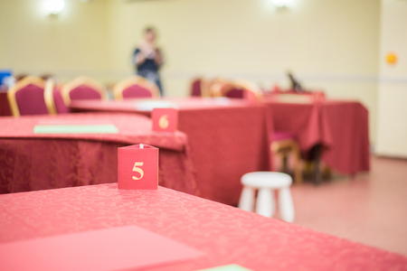 Tables covered by red material. The tables are ready for the game between the teamsの写真素材