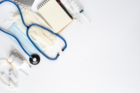 Various medical equipment and Notepad on white background. The view from the top. Copy space. Flat layの写真素材
