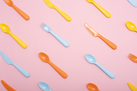 Colorful dining set on pink background . Top view.の写真素材