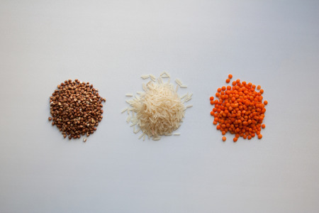 Raw buckwheat, basmati rice and red lentils isolated on white background from a high angle viewの写真素材