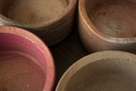 Four textured concrete pots spray painted in beige and pink colors with golden glitters close-upの写真素材