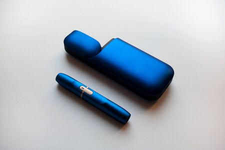 Metallic blue tobacco heating device with electronic cigarette isolated on white backgroundの写真素材
