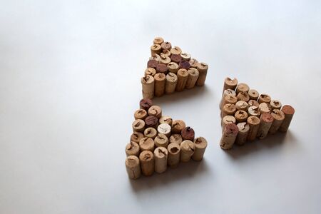 Wine corks triangles on white background with copy space
