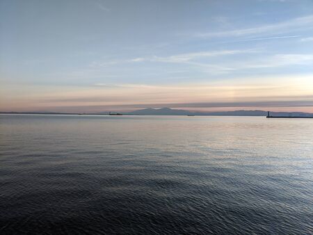 Sunset above the sea with mountain silhouette on the background from Thessaloniki coast