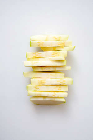 Sliced zucchini stack isolated on white background
