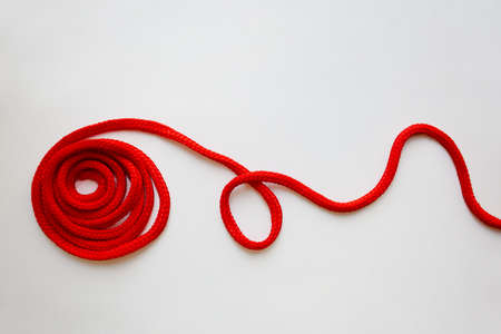 Red textured cord roll with curved line isolated on white backgroundの写真素材