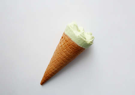 Pistachio flavored ice cream cone isolated on white background from a high angle viewの写真素材