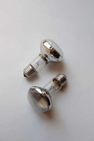 Two silver incandescent light bulbs isolated on white backgroundの写真素材