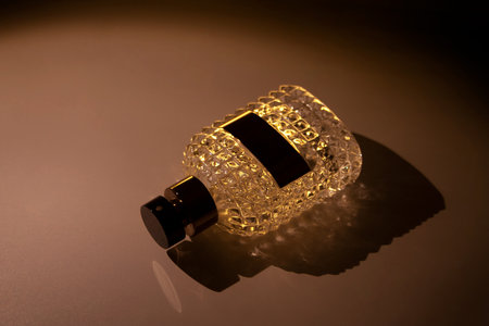 Textured glass perfume bottle isolated in dark