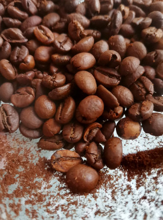 Heap of roasted coffee beans background close-up