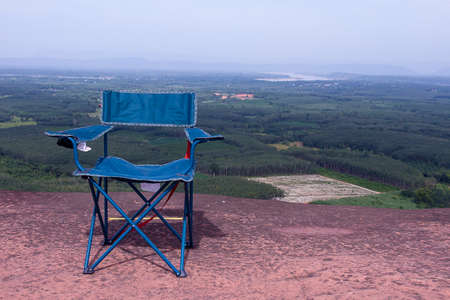 Outdoor chair camping on the mountain The back view is forest and mountain.BANGKOK THAILANDの写真素材