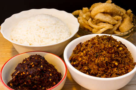 Chili paste in two white ceramic cups next to the rice bowl and the pork loin cup.Thai chili pasteの写真素材
