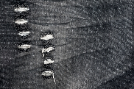 Jeans denim detail gray tear backgroundの写真素材