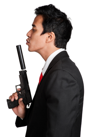 business man asian hold gun in suitの写真素材