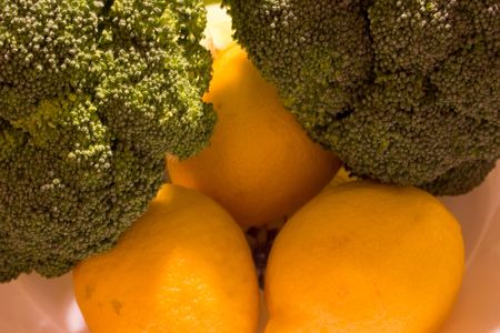 Fresh broccoli heads and lemonの写真素材