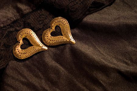 Two golden hearts over-black.の写真素材