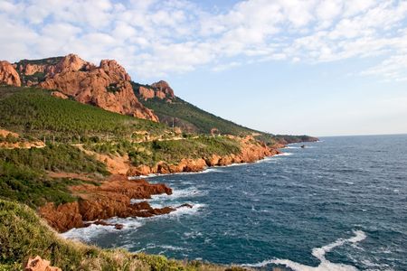 Rocky hillside, blue sky with white clouds and the Mediterranean sea.の写真素材
