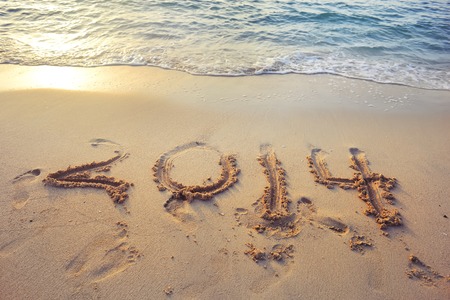 2014 written on the sand of a beautiful beach in Emirates.の写真素材