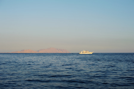 Lonely boat in Sea. Sunsetの写真素材