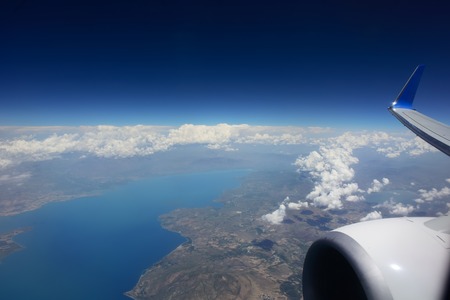 Ten kilometers high over clouds. Flying over Syria. Looking through window aircraft.の写真素材