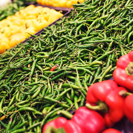 colorful bell peppers, natural background in shopの写真素材