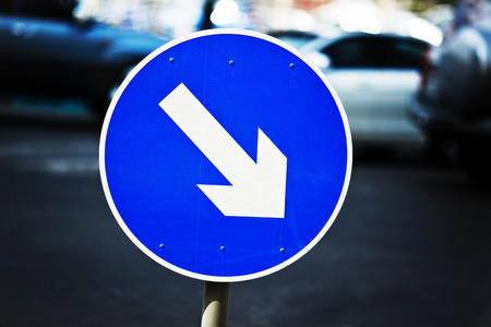 Blue street sign with arrow.の写真素材