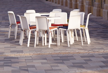 The outdoor summer cafe at empty street.