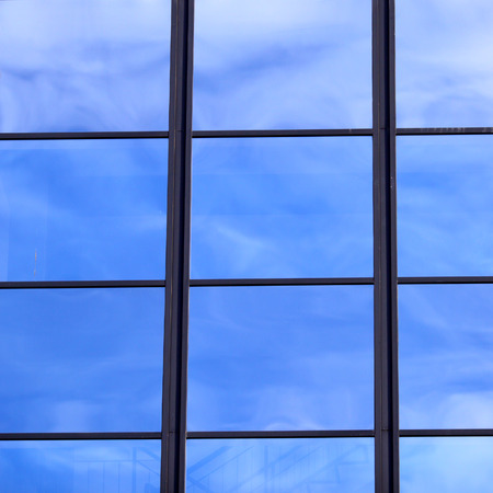 Mirror window reflects skyの写真素材
