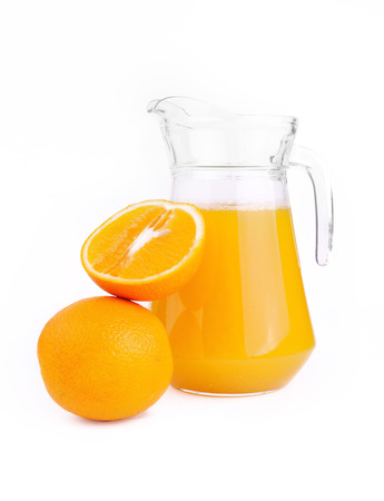 Oranges and jug of juice on a white backgroundの写真素材