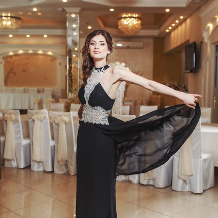 Teenage girl wearing fancy prom dress, posing on  school-leaving party.の写真素材